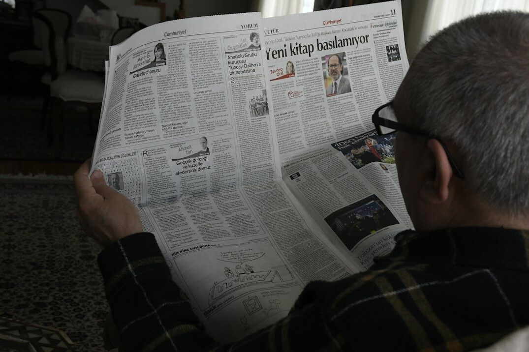 person reading newspaper